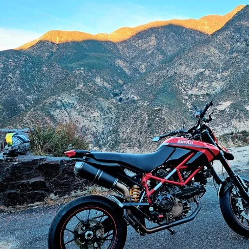 Red Ducati motorcycle on a mountain road